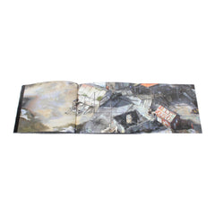 Open book or sketchbook displaying abstract artwork across its pages.